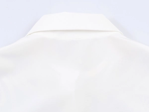 Close-up of white blouse back collar showing high-quality stitching and cotton fabric texture