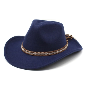Detail of navy blue cowboy hat with rhinestone-studded brown leather band and wide brim