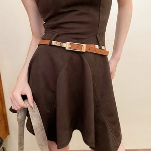 Detailed view of deep brown suede dress featuring a matching leather belt with gold buckle