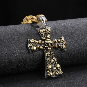 Gothic cross pendant with skull relief in gold and silver steel on display stand