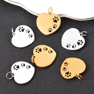 Polished stainless steel heart pendants with hollow dog paw cutouts in gold and silver
