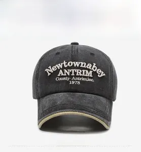 Close-up of vintage washed grey baseball cap with white embroidery and khaki piping edge