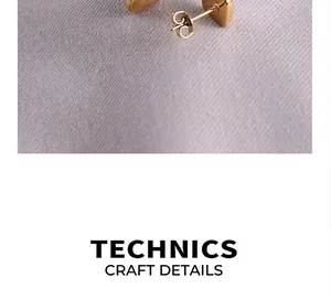 Macro shot of 18k gold heart earring showing brushed texture and detailed metalwork