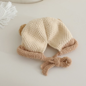 Nahaufnahme der beigen Baby-Strickmütze mit Bärenohren und weicher Strickstruktur