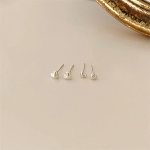 Minimalist 925 sterling silver heart stud earrings with a polished metallic finish