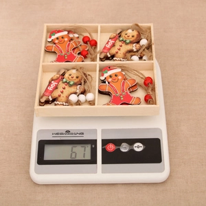 Macro shot of a four-compartment wooden box containing painted gingerbread man ornaments