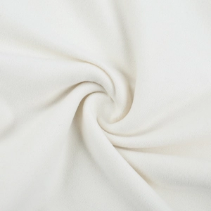 Vue macro de la texture du tissu en maille blanc montrant les fibres de coton douces