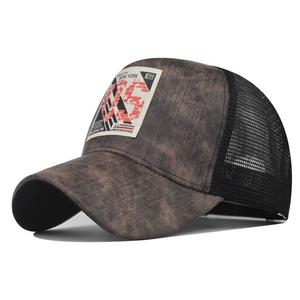 Macro shot of retro New York City patch on brown twill and mesh trucker baseball cap