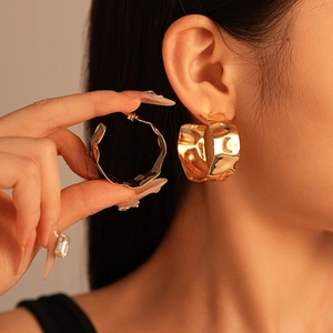 Chunky gold irregular hammer textured hoop earrings with modern lava design for women