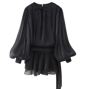 Détail de robe noire à volants avec manches lanternes transparentes et lien à la taille