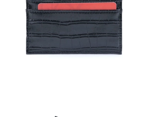 Detail of black faux leather card holder with textured crocodile pattern and card slots