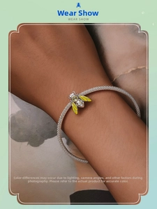 Detailed view of an S925 silver mesh bracelet featuring a yellow enamel bee charm