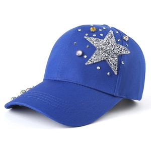 Detail of blue baseball cap featuring sparkling rhinestone star and colored gemstones
