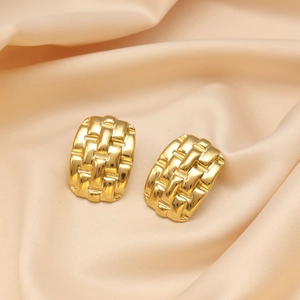 Detail of 18K gold plated earrings featuring a woven textured pattern on champagne silk