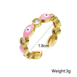 Detail view of 18K gold plated ring featuring pink evil eye and zircon inlay specs
