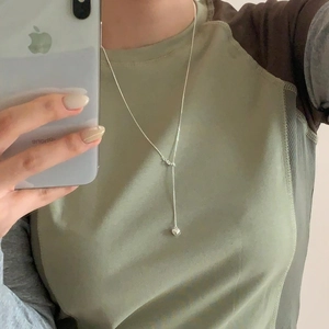 Minimalist 925 sterling silver heart necklace shown on neck in a lifestyle mirror selfie