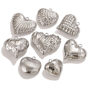 Various textured silver stainless steel heart pendants with 3D relief patterns
