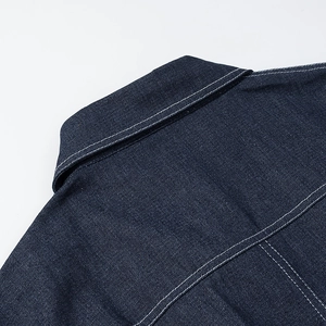 Detail of dark blue denim collar with contrast white stitching and lapel design