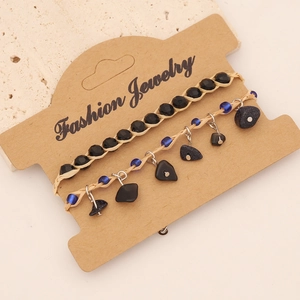 Detail of bohemian two-piece bracelet set with natural stones on a kraft card