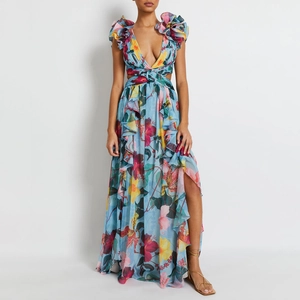 Détail d'une robe longue à fleurs avec décolleté en V et volants aux épaules pour les vacances