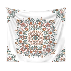 Close-up of bohemian mandala tapestry featuring detailed floral patterns and fringe details