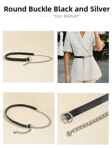 Detail of a multi-layer black leather belt with silver chain and coin charm accessory