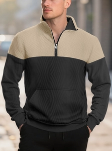 Detail of knitted men's zip polo with khaki and black patchwork and quilted textures