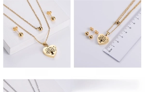 Detailed view of gold jewelry set with heart tree pendant and ruler size measurement