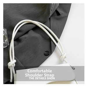 Detailed view of the white leather handbag featuring unique knotted strap craftsmanship