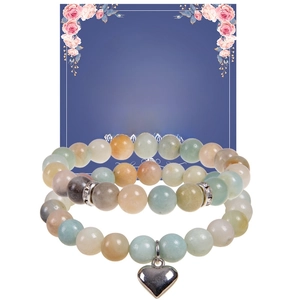 Detail of pink zebra stone beaded bracelets set with heart charm and gift card