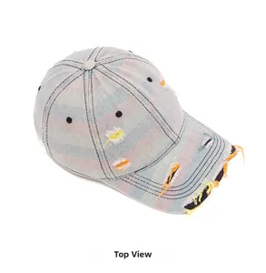 Top view of distressed denim baseball cap featuring colorful rainbow stripes and ripped details