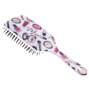 Close-up of white air cushion hairbrush with cute cosmetic prints and text