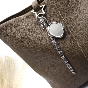 Brown leather bag with star-shaped stainless steel mesh pendant and silver mirror charm