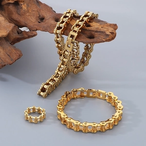 Golden stainless steel bike chain jewelry set with necklace, bracelet, and ring