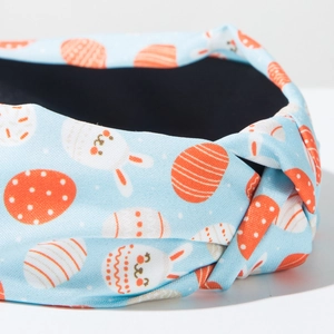 Close-up of Easter knotted headband featuring rabbit and colorful egg print patterns