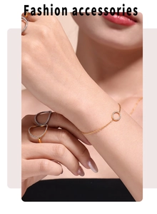 Detail of 18k gold plated geometric circle bracelet and rings with zircon inlay on model