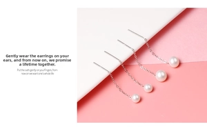 Detail view of elegant S925 silver long chain earrings with lustrous freshwater pearls