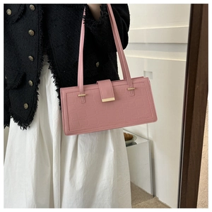 Pink croc-embossed shoulder bag detail with gold buckle and stylish tweed outfit
