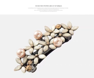 Close-up of flower spring hair clip with pink pearls and champagne rhinestones
