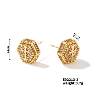 Detail view of gold hexagonal stud earrings with cross motif and pavé cubic zirconia