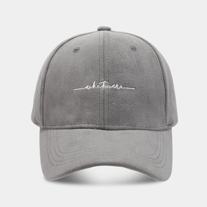 Close-up of grey baseball cap with white whatever letter embroidery and soft fabric texture