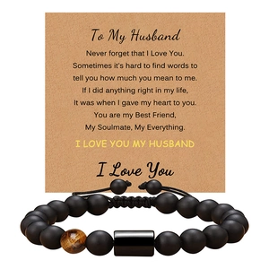 Close-up of black matte beads and tiger eye stone bracelet on sentiment card