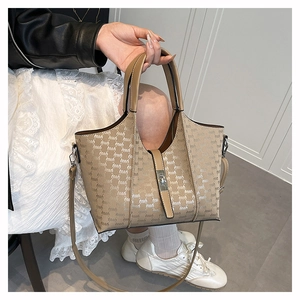 Detail of khaki PU leather tote bag with embossed letters and metallic twist lock closure