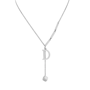 Detailed macro view of silver necklace with letter D pendant and small cube charms