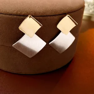 Minimalist geometric square earrings with gold and silver two-tone brushed metal finish