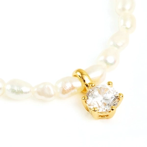 Detail of silver octagonal star pendant with diamonds and irregular white pearls