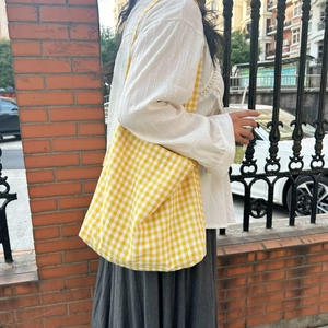 Detail of yellow gingham canvas tote bag showing large capacity for students and shopping