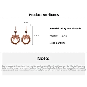 Detail view of vintage bronze butterfly earrings with wooden beads and woven rings