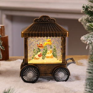 Close-up of vintage bronze Christmas cart light with Santa Claus and spinning glitter