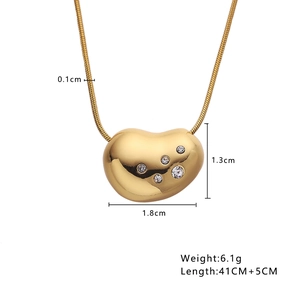 Close-up of heart-shaped gold necklace with zirconia stones and size specifications